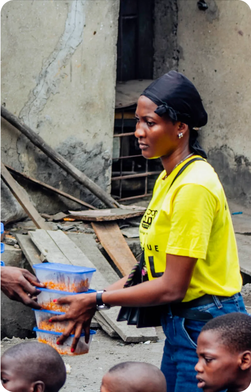 a lady handing over plates of food stacked upon eachother to someone